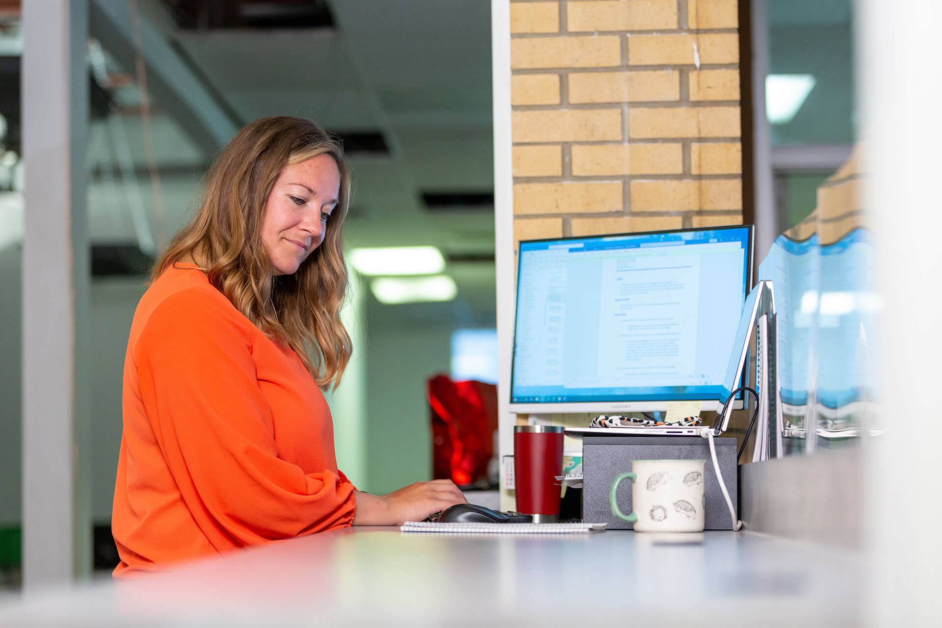 business professional working at a standing computer station