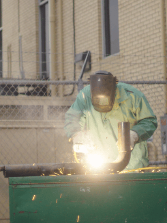 Construction worker welding metal at work