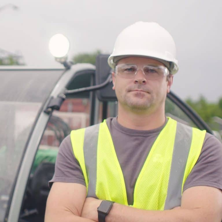 Temp to hire worker standing by machine