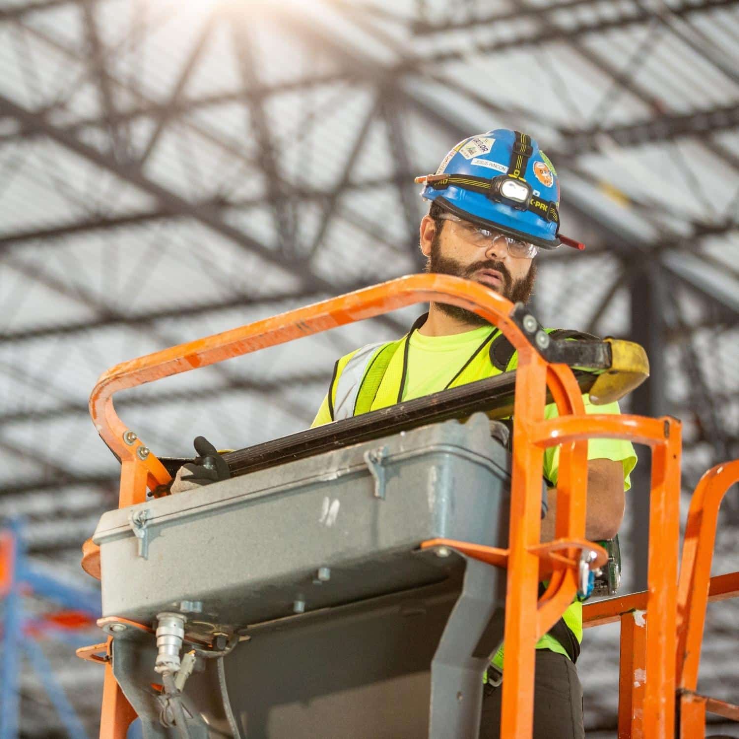 A staffed construction worker in a lift