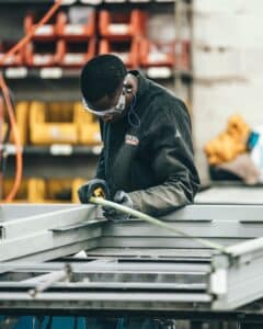 Man measuring in manufacturing facility